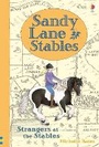 Cover: Sandy Lane Stables Strangers at the Stables - Usborne Publishing Ltd