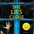 Cover: She Lies Close - Blackstone Publishing